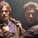 Jared Padalecki's Sam Winchester has his jacket being grabbed on both sides by Jensen Ackles' Dean Winchester.